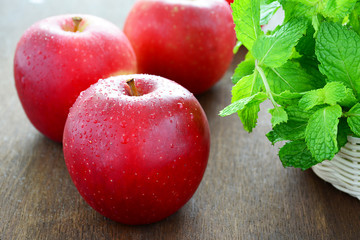 Close up red apples on wooden table.