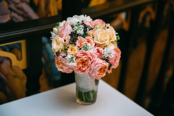 beautiful bridal bouquet standing in a glass on a table