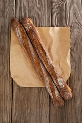 Baguettes on wooden background