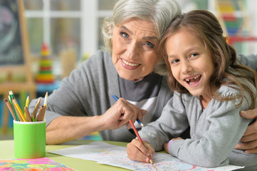 Grandmother and granddaughter drawing