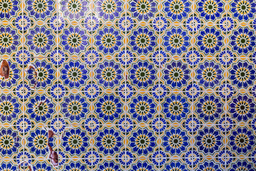 Tunisian tiles with traditional geometric shapes , ceramic tile covered wall texture background