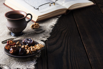 Cup of coffee and book on wooden table