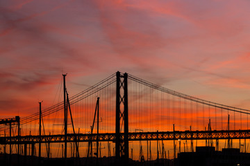 sunset landscape in city with bridge and yachts
