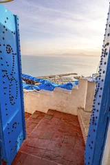 Foto op Canvas Typical Tunisian, Arabian, Mediterranean architecture in Sidi Bou Said, famous touristic town near Tunis, Tunisian capital.North African Mediterranean coast. © EnginKorkmaz