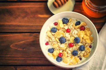 Healthy Breakfast Muesli with berries,honey and milk 