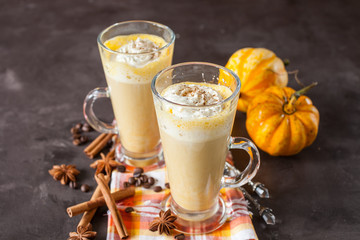 pumpkin latte in a glass on a table, selective focus