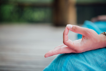 Woman meditating in the lotus position closeup. Hands close-up.