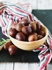 Fresh chestnuts in yellow bowl