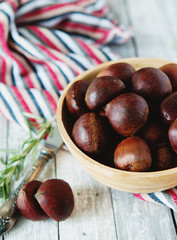 Fresh chestnuts in yellow bowl