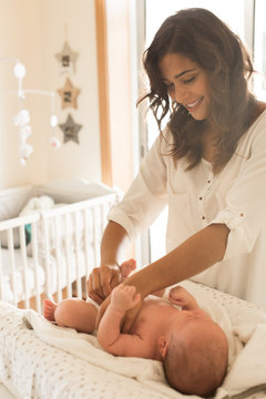 Mother Changing Baby's Diaper