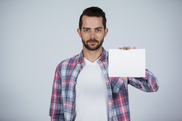 Confident man holding a blank placard