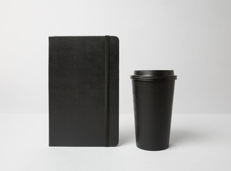 Black paper cup and moleskine