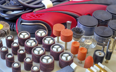 Mini drill machine with set of different grinding and cutting accessories closeup