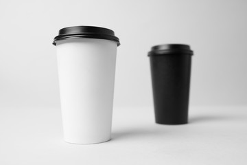 Black and white paper cup with a black capmockup