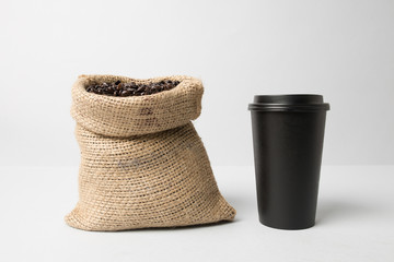Black paper cup mockup with coffee sack
