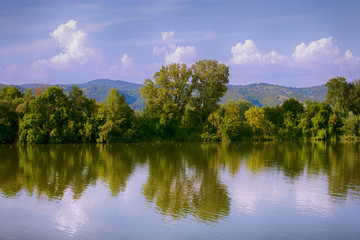 Fototapeta na wymiar Surrealistic scenery, lake,trees and hills