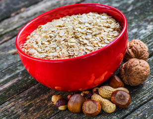 Oatmeal or oat flakes on dark wooden table