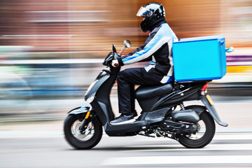 Obraz na płótnie Canvas scooter delivery service in motion blur