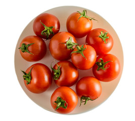Red tomatoes on a plate isolated background top view