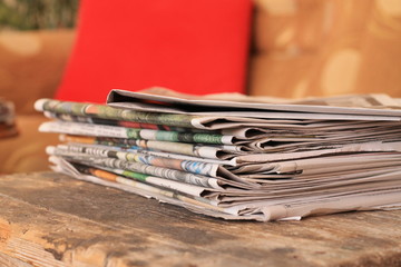 Newspapers on wooden table