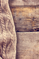 knitted plaid, sweater on old wooden boards