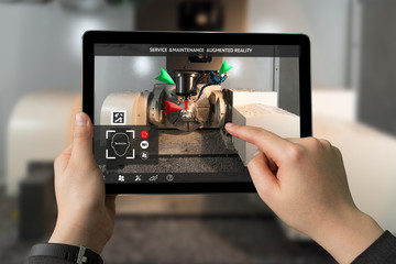 Industrial 4.0 , Augmented reality concept. Hand holding tablet with AR service , maintenance application and calling technician for check destroy part of smart machine in smart factory background - obrazy, fototapety, plakaty