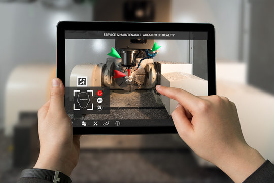Industrial 4.0 , Augmented reality concept. Hand holding tablet with AR service , maintenance application and calling technician for check destroy part of smart machine in smart factory background