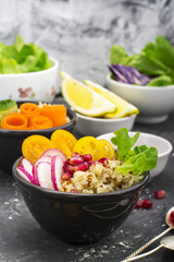Vegetarian Quinoa bowl. Healthy breakfast or snack with detox , tomato, cucumber, carrot, pomegranate seeds, juicy blueberries and lettuce in portioned bowls. Top view