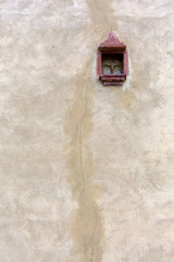 old wall with a small Christian cross