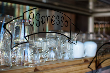 Fototapeta na wymiar Empty glasses on the bar rack in coffee shop.
