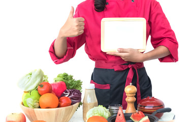 Chef cook giving thumbs up with blank menu board  in kitchen