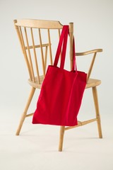 Red bag hanging on a wooden chair