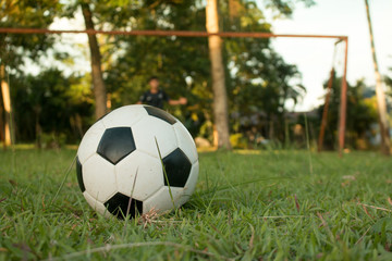 Boy kicking soccer ball on sports field. Soccer football trainin