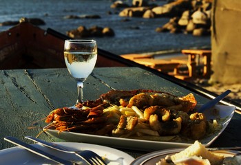 glass of white wine and plate seafood, selective focus