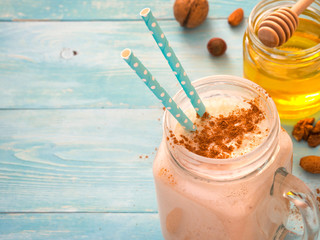 Banana smoothie on turquoise background with copyspace