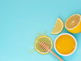 Lemon and honey on blue with copy space