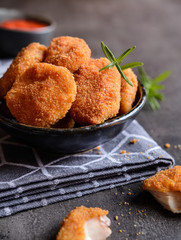 Fried breaded chicken nuggets with tomato sauce
