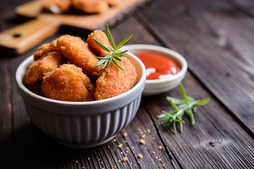 Fried breaded chicken nuggets with tomato sauce