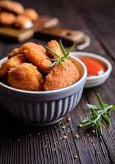 Fried breaded chicken nuggets with tomato sauce