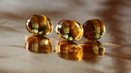 many oil capsules on a gold background. fish oil on a gold background