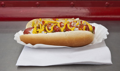 Chili dog with mustard and catsup on diner counter. Horizontal.