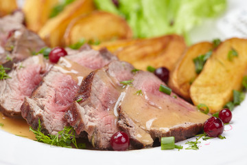 Tasty roasted pork meat with potatoes