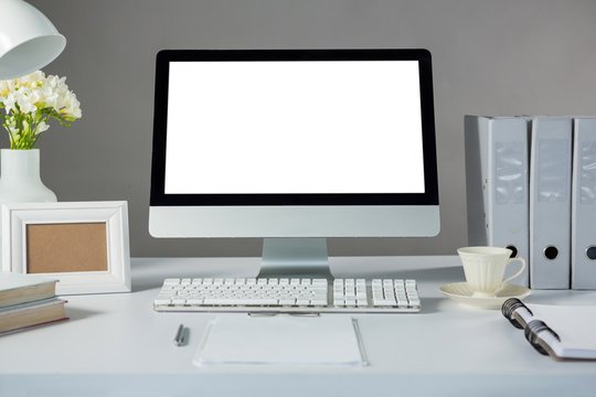 Desktop pc with picture frame and cup of coffee 