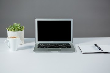 Fototapeta premium Laptop with cup of coffee and diary 