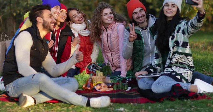Friends Picnic People Group Sitting Blanket Using Cell Spart Phone Outdoor Autumn Park Slow Motion 60