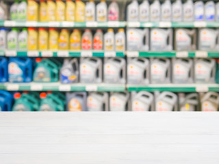 Blurred motor oil on shelves in supermarket