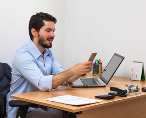 Fototapeta premium Male holding cellphone at office