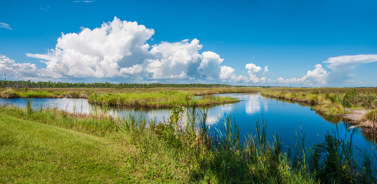 Panorama of canals in Gulf Shores State Park in Alabama USA with reflections of sky on water