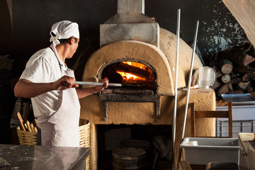 Pizza chef at the oven