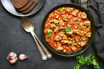 Veal stewed with vegetables in tomato sauce.Top view.